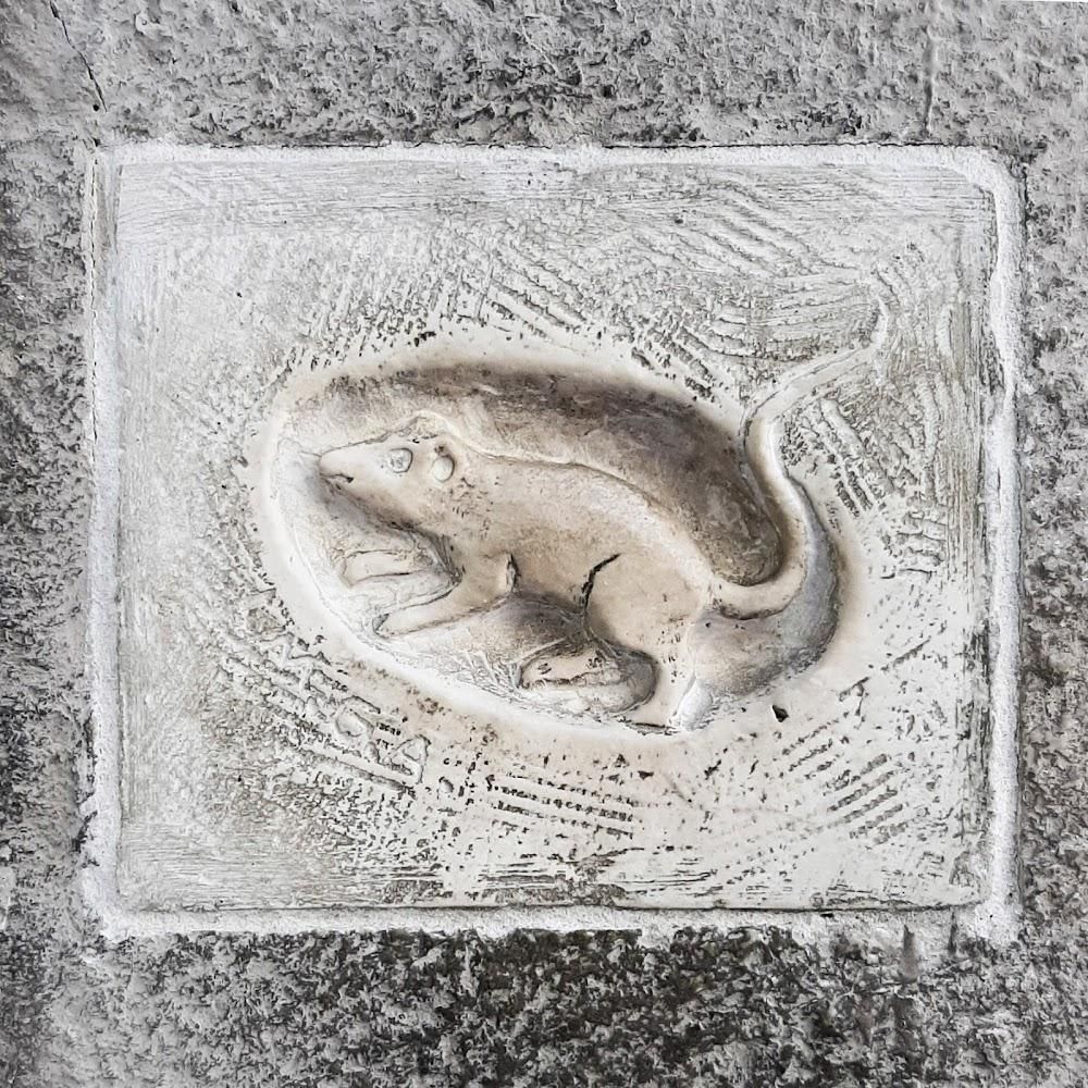 Stone carving of a rat.